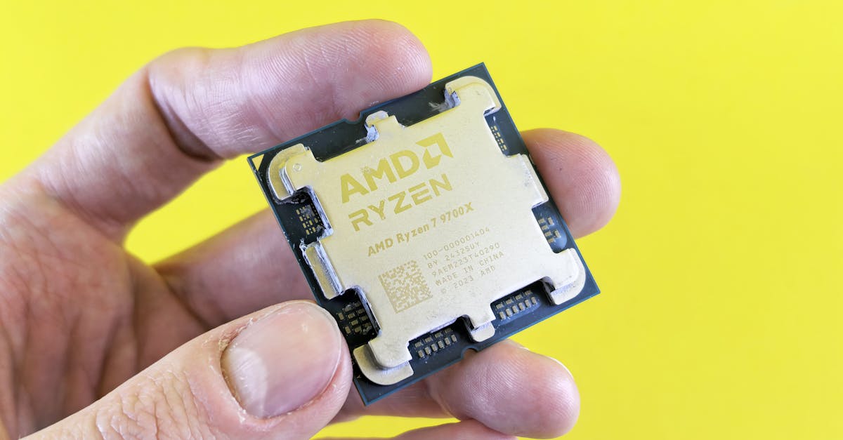 Close-up of an AMD Ryzen processor held against a yellow background