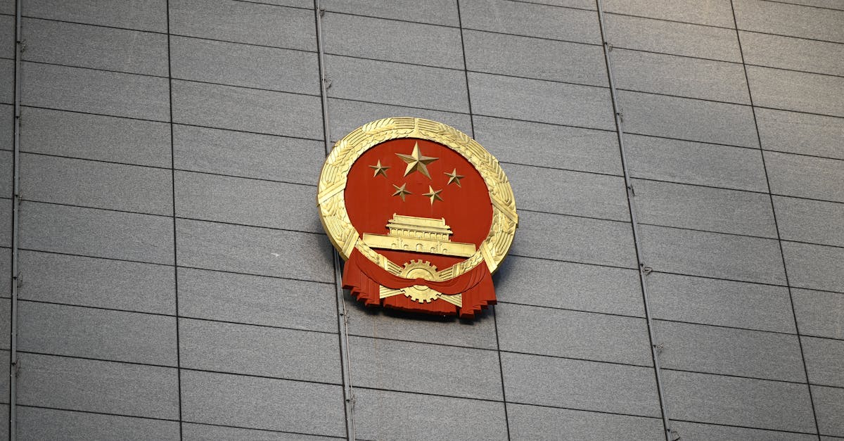 Chinese national emblem mounted on a government building facade in Beijing