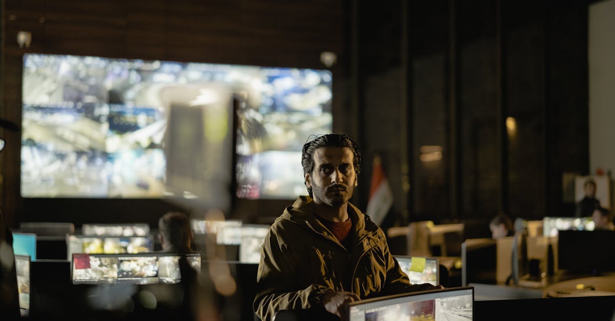 Operators in a control room monitoring multiple surveillance and data feeds