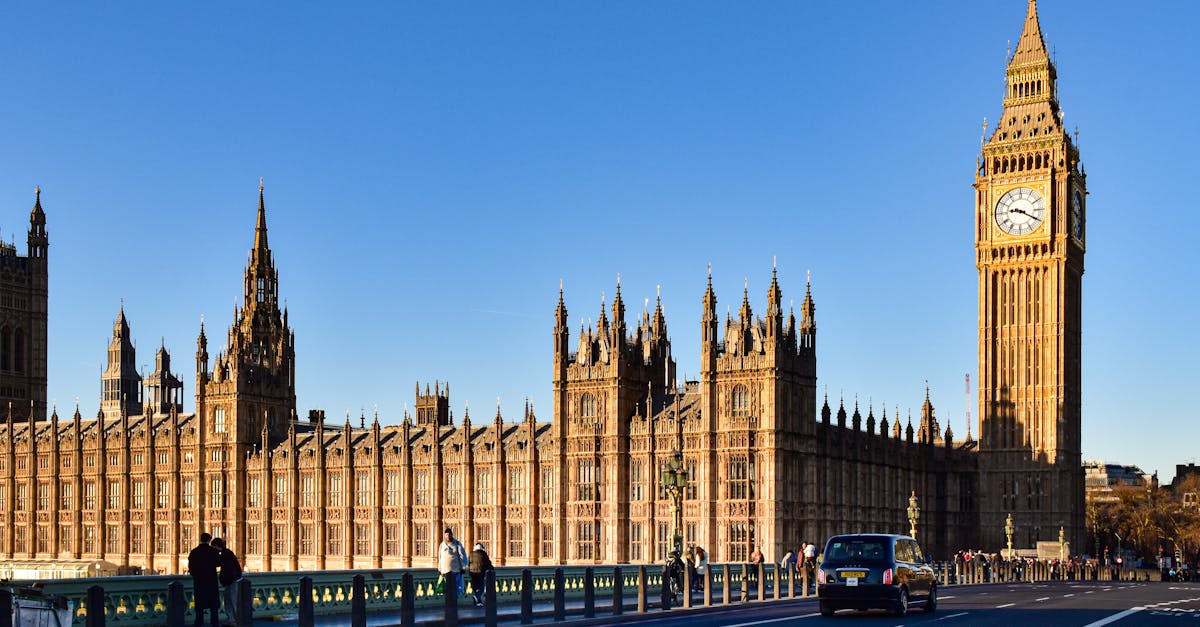 Big Ben and the Houses of Parliament in Westminster, London, under a blue sky