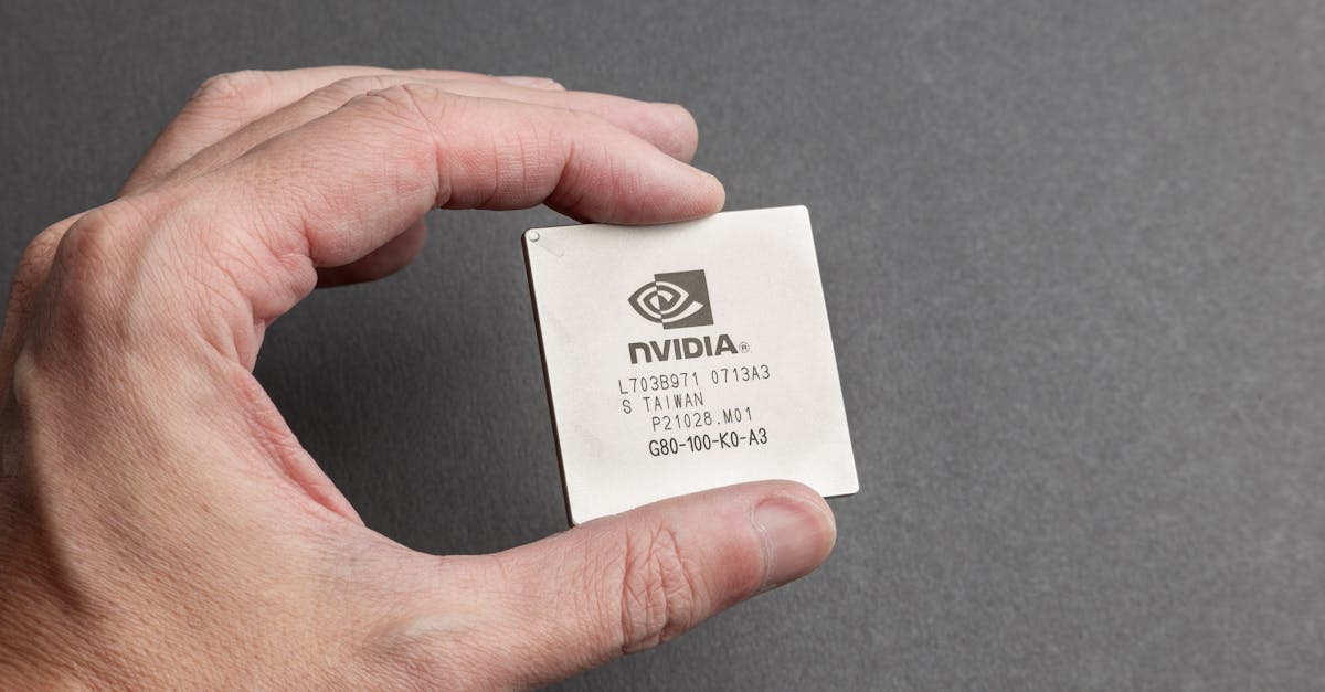 A close-up of a semiconductor chip in a person's hand
