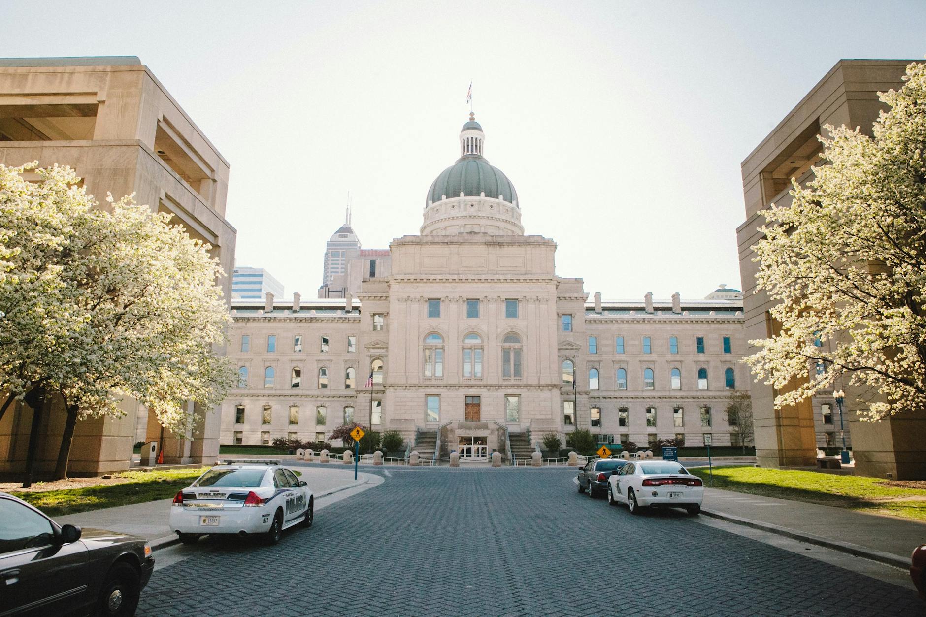 Indiana State Capitol building in Indianapolis with spring trees in bloom