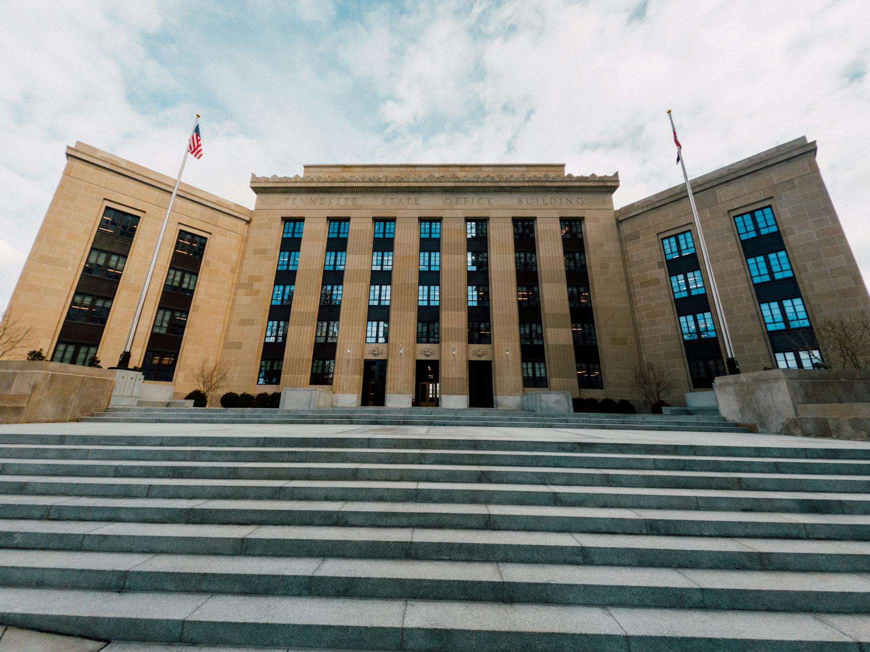 Federal Reserve building exterior with American flags and entrance staircase, Washington D.C.