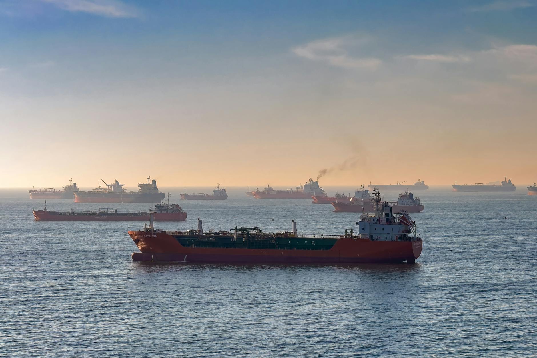 Oil tanker navigating the Strait of Hormuz with Middle East coastline visible