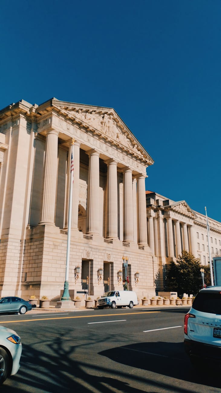 Neoclassical federal building facade in Washington D.C. under a clear sky