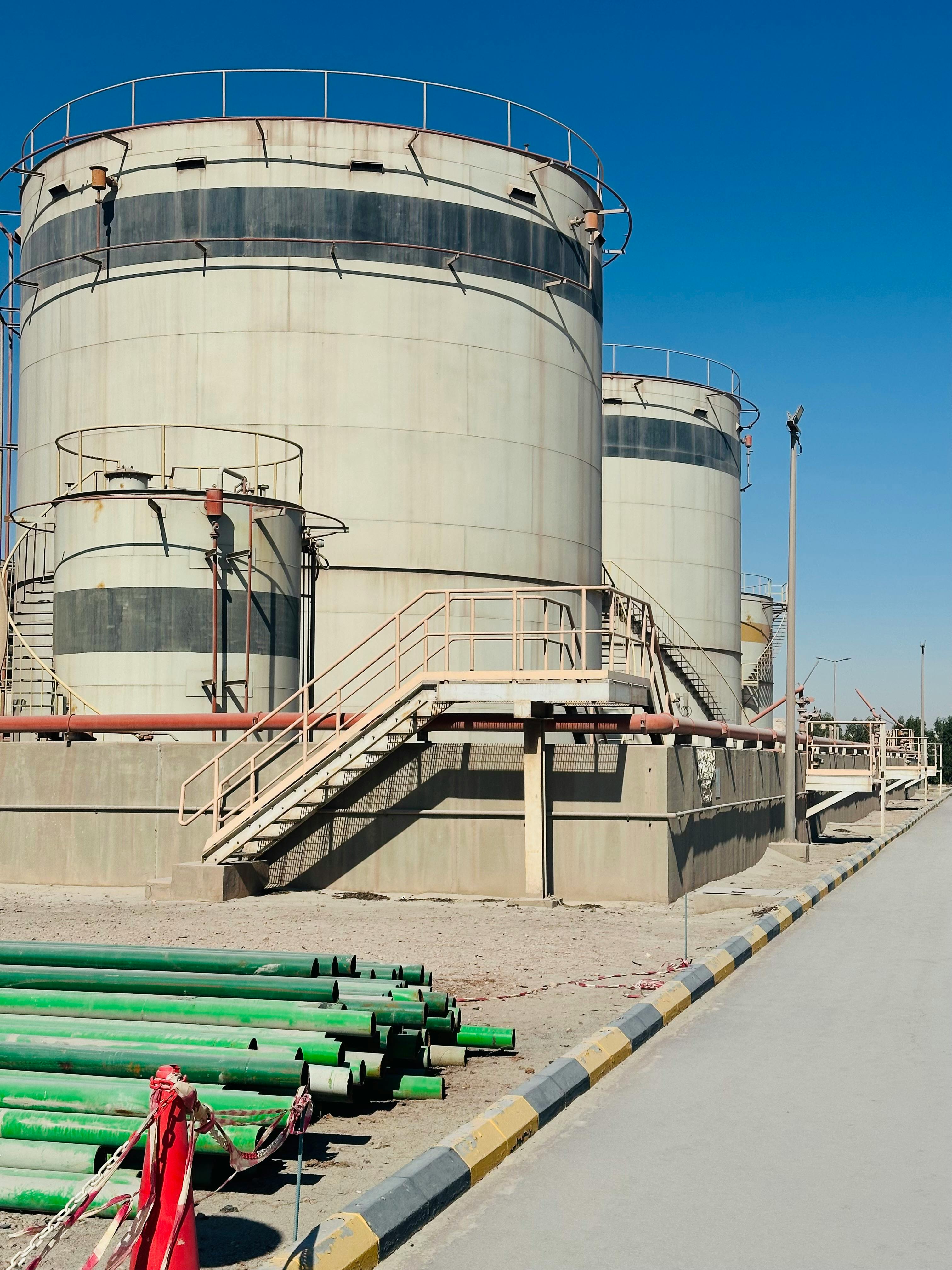 Storage tanks at an Aramco oil facility in Saudi Arabia under clear blue sky